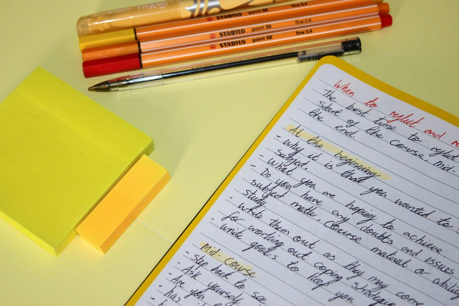Notebook with handwritten headline ideas for an online course sales page