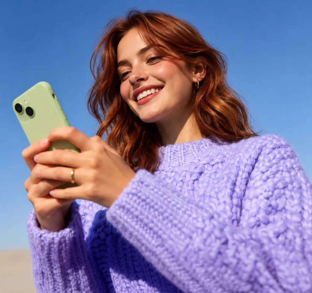Woman smiling at an email on her phone